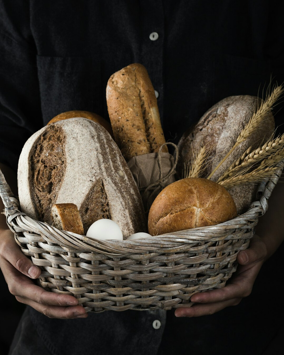 Danish baker pulling fresh rye bread from a wood oven