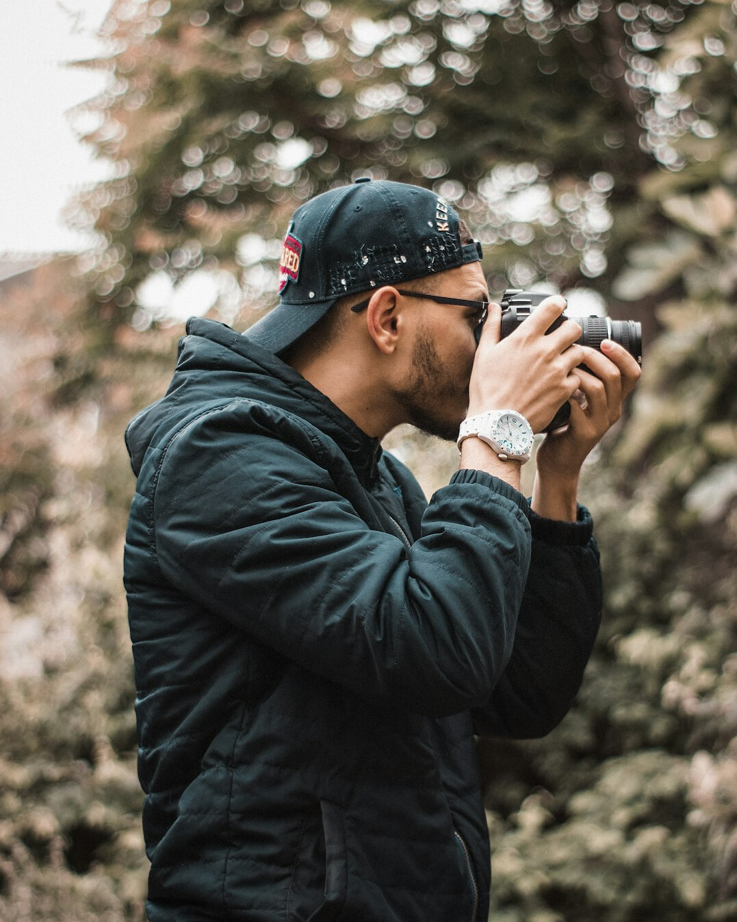 Danish photographer holding a camera on a quiet street