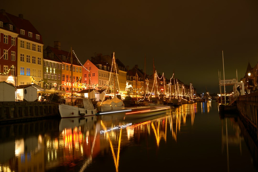 Colorful old harbor houses along a Danish canal at dusk